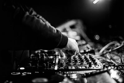 A b/w photo of a dj mixing music in a club 