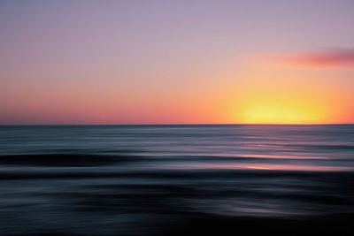 Scenic view of sea against romantic sky at sunset