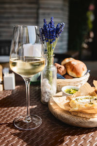 Glass of cold white wine and oven baked camembert cheese