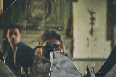 Portrait of people looking through glass window