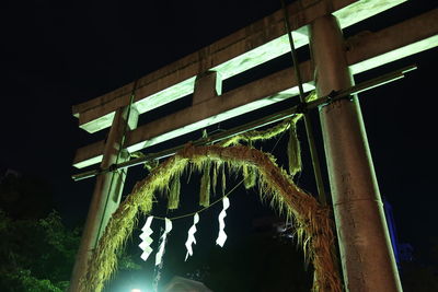 Low angle view of bridge against sky at night