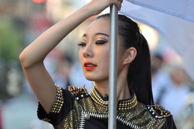 Portrait of young woman looking away outdoors