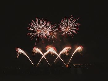 Low angle view of firework display at night