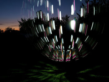 Close-up of illuminated lights on field at night