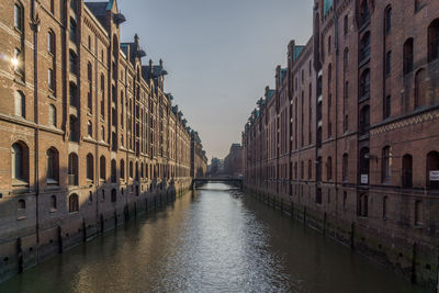 Canal amidst residential buildings in city