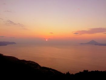 Scenic view of silhouette mountain against romantic sky at sunset