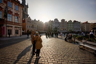 People walking on street amidst buildings in city