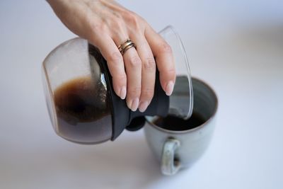 Midsection of man holding coffee cup