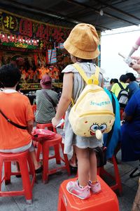 Rear view of people sitting in market