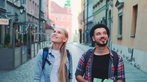 Young couple standing on street in city