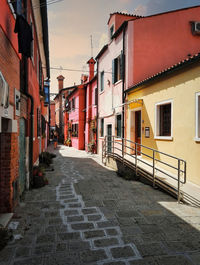 Empty alley amidst buildings in city