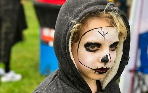 Close-up portrait of boy with face paint