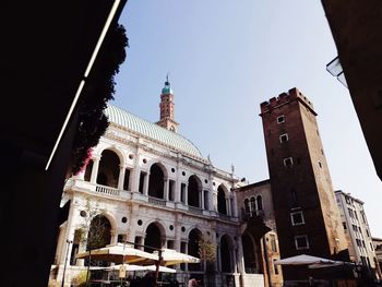 Low angle view of buildings in city against clear sky