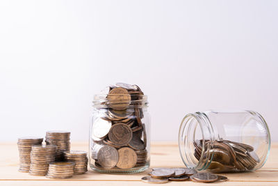 Close-up of coins on table against white background