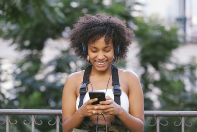 Young woman using mobile phone outdoors