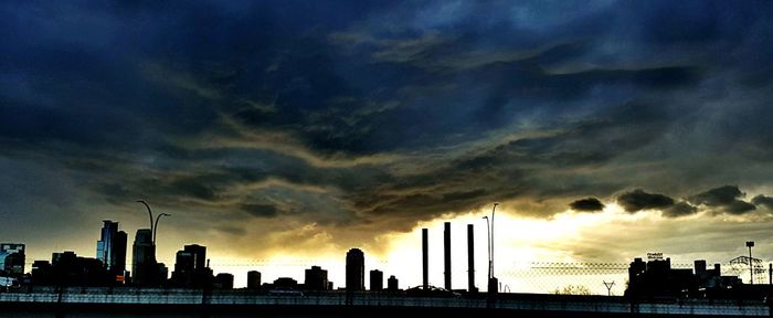 Silhouette buildings against sky during sunset