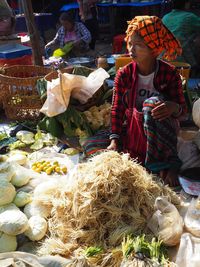 Full length of man for sale at market stall