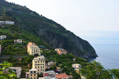 High angle view of houses by sea against sky
