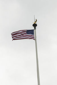 Low angle view of flag against clear sky