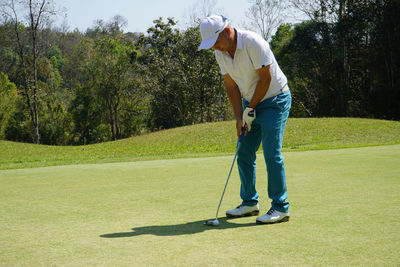 Full length of man playing golf