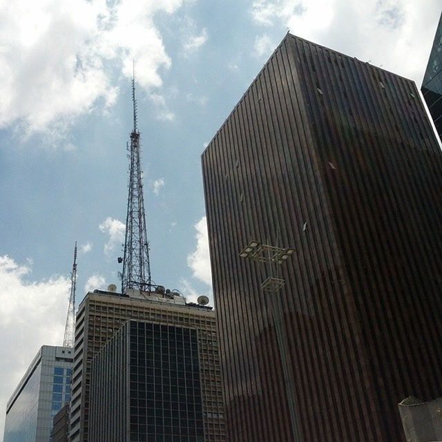 building exterior, architecture, built structure, sky, low angle view, tall - high, tower, city, skyscraper, cloud - sky, office building, modern, cloud, cloudy, building, tall, day, development, outdoors, no people