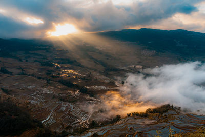 Aerial view of landscape against sky during sunset