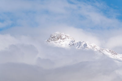 Low angle view of snowcapped mountains against sky