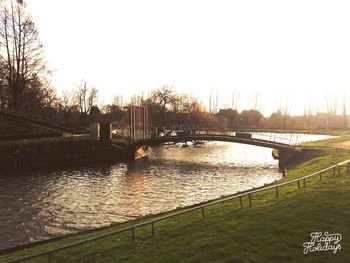 Bridge over river at sunset