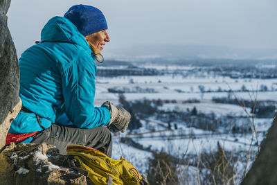 Enjoying warm sun rays on cold day after climbing