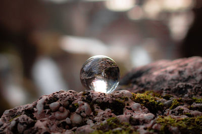 Close-up of crystal ball on rock