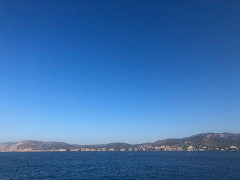 Scenic view of sea against clear blue sky