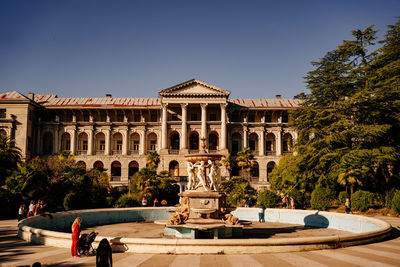 Statue in front of historical building