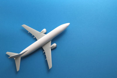High angle view of toy airplane on blue background