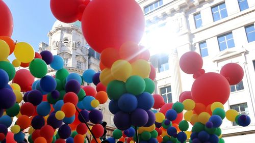 Low angle view of balloons against sky