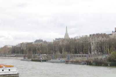 Panoramic view of river and buildings against sky