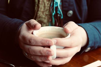 Close-up of hands holding bowl