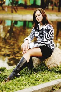 Portrait of young woman sitting on grass