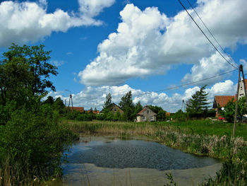 Scenic view of lake by building against sky