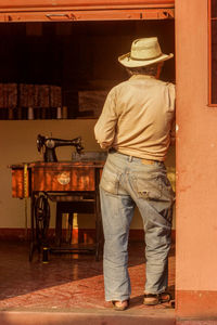 Rear view of man standing in front of building