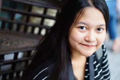 Portrait of smiling woman sitting outdoors