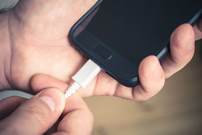 Close-up of hand holding mobile phone