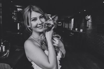 Portrait of smiling young woman at night