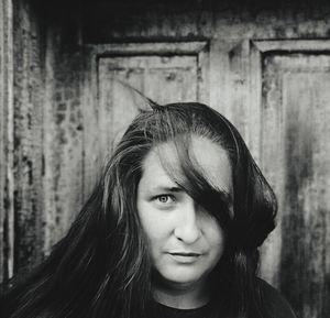 Portrait of beautiful woman against wall