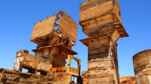 Low angle view of old ruins against clear sky