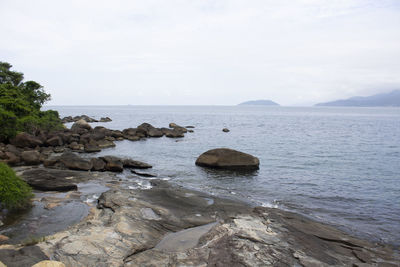 Rocks on beach against sky