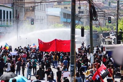 People on street against buildings in city