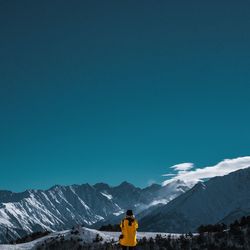 View of mountain range against blue sky