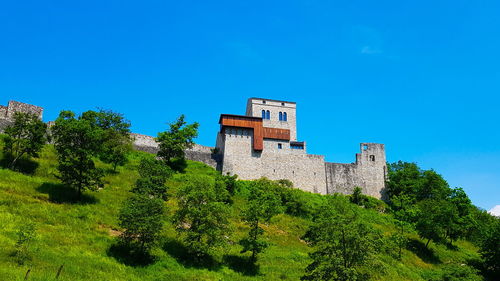 Low angle view of building against clear blue sky