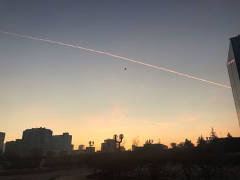 Low angle view of silhouette buildings against sky during sunset