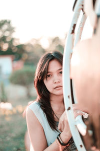 Portrait of beautiful woman standing against blurred background